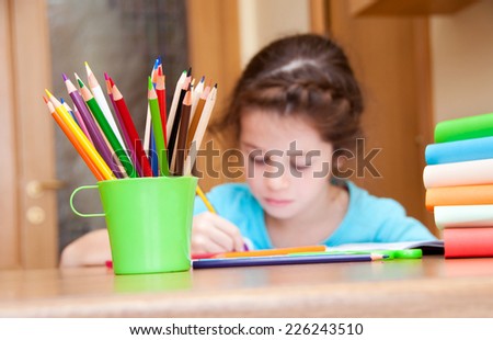 Girl writing on desk