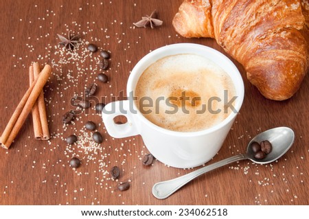 Cup of cappuccino and croissant for breakfast
