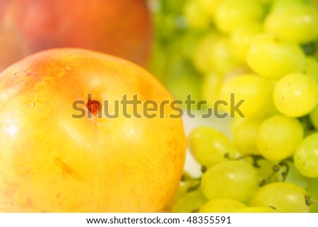 ripe juicy peach and green grape (close up)