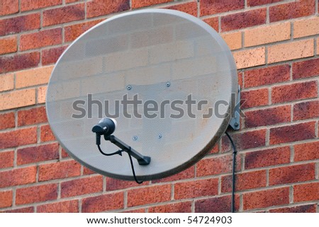 Satellite dish mounted on a brickwall
