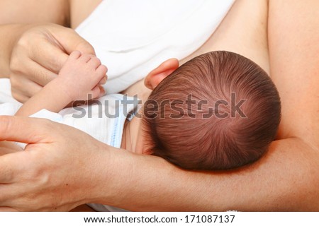 A baby being breastfed A baby being breastfed