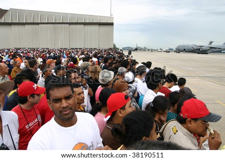 SUBANG, MALAYSIA - OCTOBER 3: The big crowd eagerly waiting for the Thunderbirds\' airshow to begin on October 3, 2009 in Subang, Malaysia.