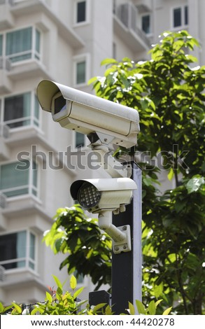 A security camera with LED light at the perimeter of a residential building