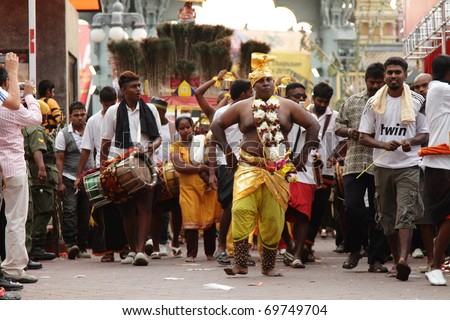 BATU CAVES, MALAYSIA - JANUARY 19:A man in trance walks ahead of a Kavadi procession during the Hindu festival of Thaipusam on January 19, 2011 in Batu Caves, Malaysia.