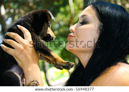 A cute terrier mix breed pup being held