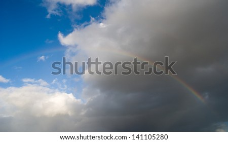 A rainbow over a dark sky after the storm.