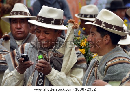 ORURO, BOLIVIA - FEB 16: Indio with mobile phone at Oruro Carnival in Bolivia, declared UNESCO Cultural World Heritage. February 16, 2012 in Oruro, Bolivia