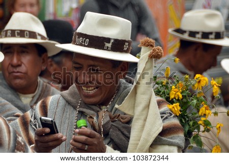 ORURO, BOLIVIA - FEB 16: Indio with mobile phone at Oruro Carnival in Bolivia, declared UNESCO Cultural World Heritage. February 16, 2012 in Oruro, Bolivia