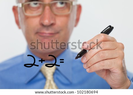 Man writing numbers on a glass board