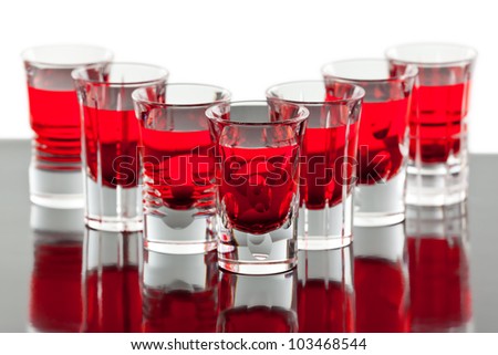 Beautiful shot crystal glasses with red liquid