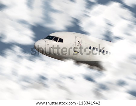 Close up of an airplane\'s nose flying through the clouds