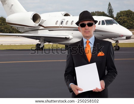 Business man next to a private jet