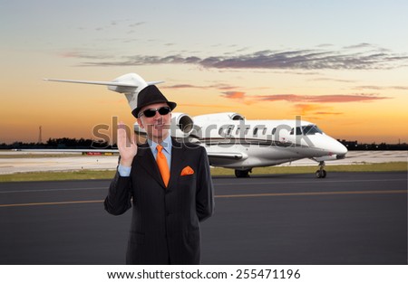 Business man waving near a private jet