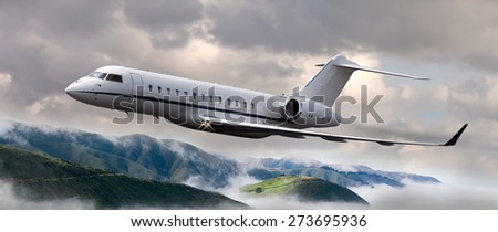 Private jet flying over mountains