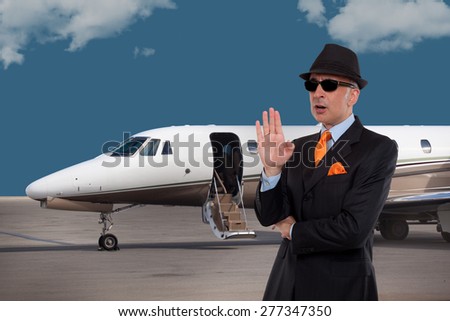 Business man talking next to a private jet