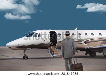 Business man walking toward a private jet