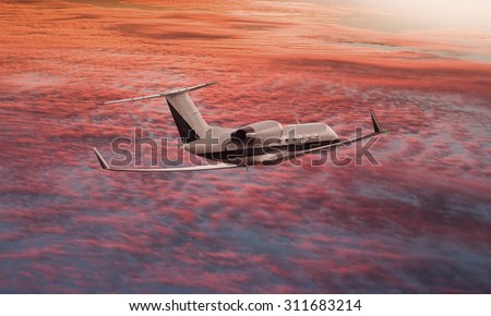 Private jet flying over a sunset sky