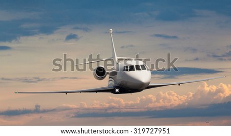 Frontal view of a private jet flying