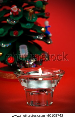Beautiful votive candle with Christmas detail in the background