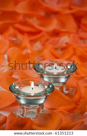 Beautiful votive candles with rose petals around them