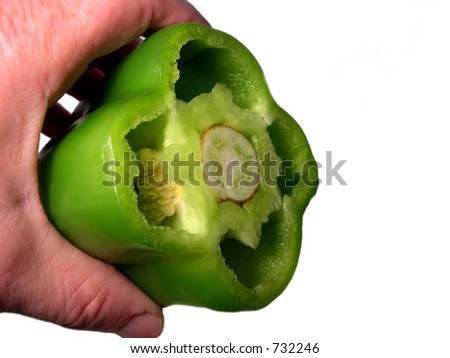 Hand holding cut green pepper