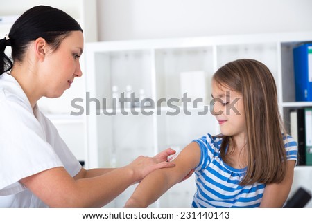 little girl receiving injection with a smile little girl receiving injection with a smile