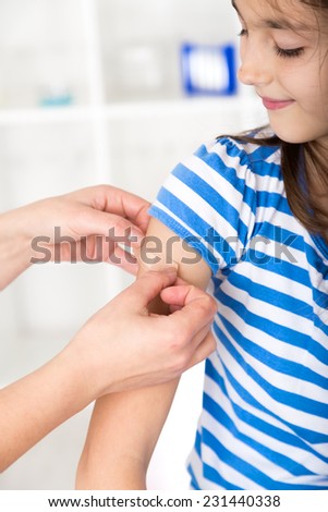 Nurse  putting a plaster over the wound.