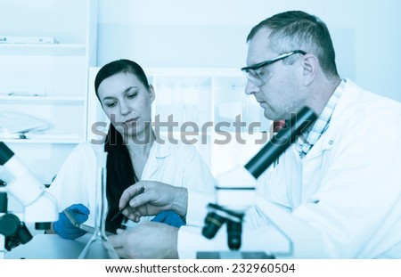 Couple of scientists at work in a laboratory .
