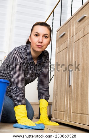 Young woman washing furniture at home