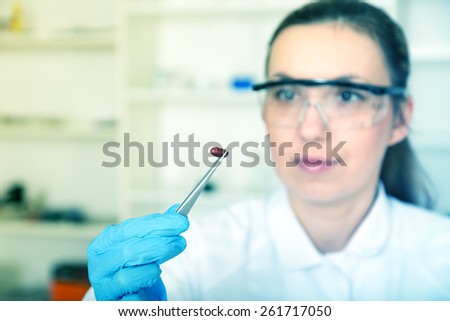 woman laboratory assistant in the laboratory of food quality.color toned image