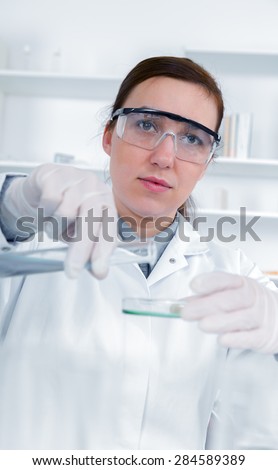 female researcher with glass equipment in the lab