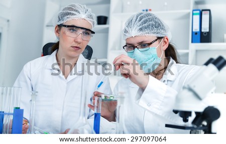 Team of scientists in a laboratory working on chemical testing.