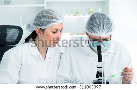 Team of scientists in a laboratory working on chemical testing