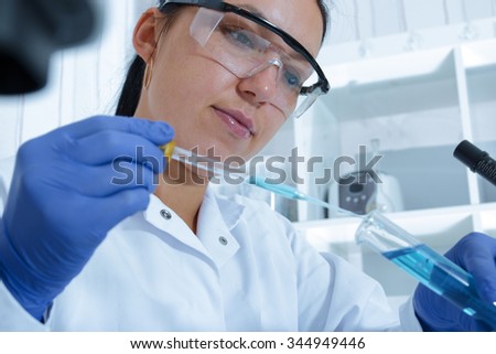 female researcher with glass equipment in the lab.Toning image