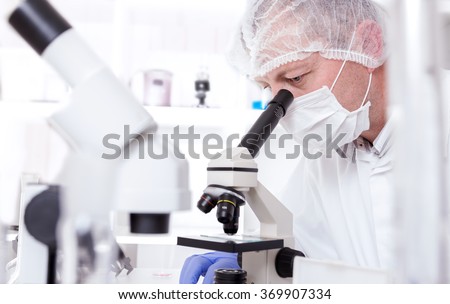 Laboratory assistant in the laboratory of of food quality.Cell culture assay to test genetically modified seed.