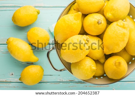 Fresh lemons in retro colander.