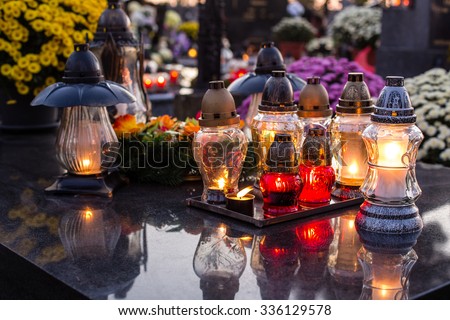 Candles burning at a cemetery during All Saints Day. Shallow depth of field.