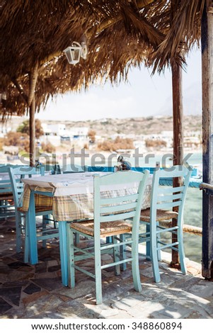 Traditional greek tavern located in a small fishing port. Karpathos island. Greece. Shallow depth of field.