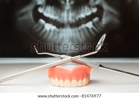 Dental pan x-ray, denture and dental instruments.