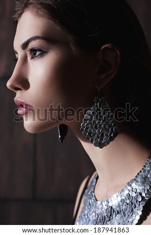 Fashion Model Girl Portrait. Trendy Hair Style. Hairstyle. Beauty Woman closeup. Fringe. Hairdressing. Silver Metallic Accessories and Manicure