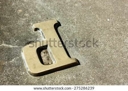 Metal letter P on a concrete background