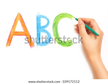 Woman\'s hand holding a pencil and writing ABC alphabet on a white white background