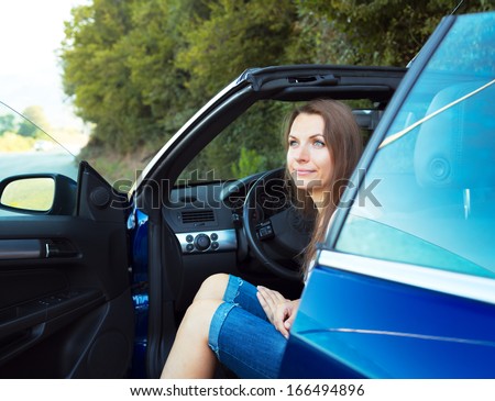 Happy caucasian woman in a cabriolet car
