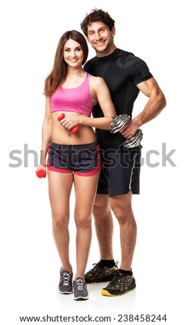 Athletic couple - man and woman with dumbbells on the white background