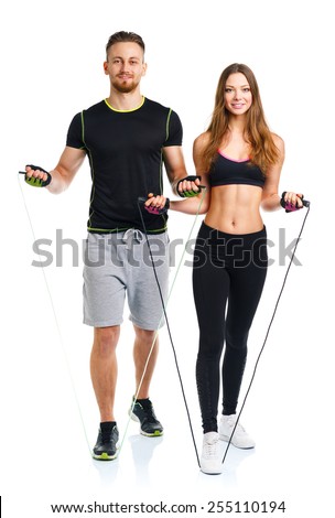 Happy sport couple - man and woman with with ropes on the white background