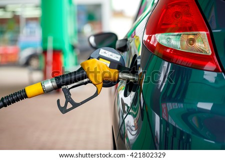 Car refueling on a petrol station closeup