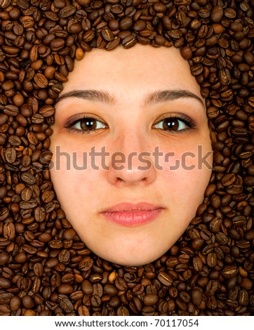 Coffee beans around of face beautiful young woman