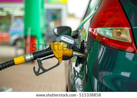 Car refueling on a petrol station closeup