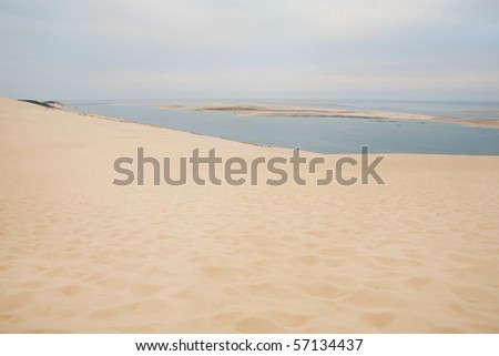 Cloudy sky over sand dune - eastern France - ocean in the horizon