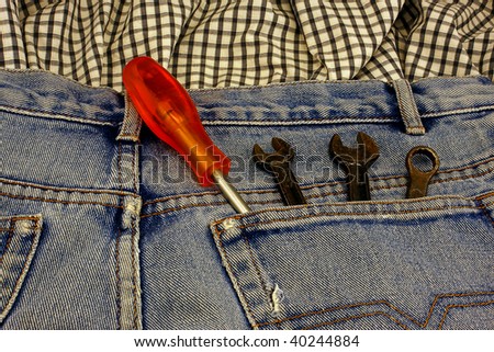 an old pair of jeans with tools card in the pocket